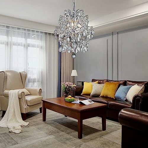 Elegant living room with chandelier, leather sofa, armchair, and coffee table.