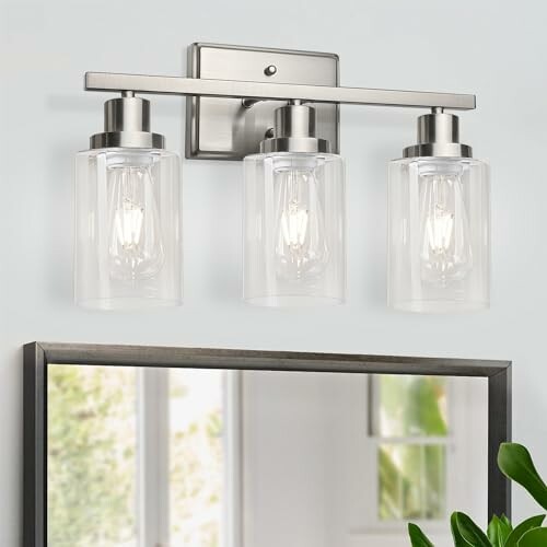 Three-light modern bathroom wall fixture above mirror