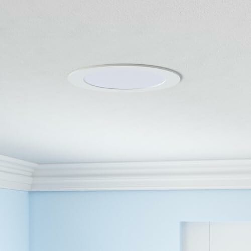 Modern ceiling light fixture in a room with crown molding